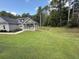 Home featuring a lush lawn and covered porch, accented by a variety of trees offering a tranquil and private setting at 190 Paul Aiken Rd, Dallas, GA 30157