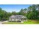 Charming single-story home with a manicured lawn and inviting front porch, set against a backdrop of lush trees at 190 Paul Aiken Rd, Dallas, GA 30157