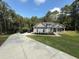 Inviting home featuring a long driveway and well-manicured front yard, framed by lush greenery for added curb appeal at 190 Paul Aiken Rd, Dallas, GA 30157
