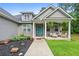 Close-up of a cozy front porch with stylish seating and decorative hanging plants at 190 Paul Aiken Rd, Dallas, GA 30157