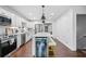Bright kitchen boasts stainless steel appliances, white cabinetry, and an island with a beverage refrigerator at 190 Paul Aiken Rd, Dallas, GA 30157