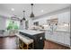 Modern kitchen features white cabinets, a central island with seating, and stainless steel appliances at 190 Paul Aiken Rd, Dallas, GA 30157