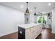 Bright kitchen island features white cabinets, dark wood accents, marble countertop, and pendant lighting at 190 Paul Aiken Rd, Dallas, GA 30157
