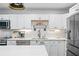 Bright kitchen with white cabinets, stainless steel appliances, and marble countertops at 190 Paul Aiken Rd, Dallas, GA 30157