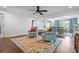 Spacious living room with hardwood floors, ceiling fan, and view into dining room at 190 Paul Aiken Rd, Dallas, GA 30157