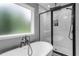 Modern bathroom with soaking tub and separate shower featuring black trim and white subway tile at 190 Paul Aiken Rd, Dallas, GA 30157