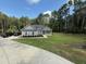 Charming home boasts a lush, green lawn and covered porch, enhanced by mature trees providing privacy at 190 Paul Aiken Rd, Dallas, GA 30157