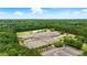 Aerial view of the community school, surrounded by green forest and a large parking area at 1925 Waters Ferry Dr, Lawrenceville, GA 30043