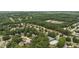 Aerial view showcases the community, surrounding golf course, lush trees, pool, and tennis courts at 1925 Waters Ferry Dr, Lawrenceville, GA 30043
