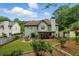 Exterior view of the house featuring a covered patio, fire pit area, and landscaped yard at 1925 Waters Ferry Dr, Lawrenceville, GA 30043