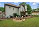 A spacious backyard boasts a covered patio, a fire pit, and a well-manicured lawn at 1925 Waters Ferry Dr, Lawrenceville, GA 30043
