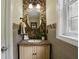 Stylish half bathroom featuring wood accent wall, granite countertop, and updated fixtures at 1925 Waters Ferry Dr, Lawrenceville, GA 30043