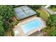 Aerial view featuring a large community pool, tennis courts, and surrounding trees at 1925 Waters Ferry Dr, Lawrenceville, GA 30043
