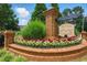 St. Johns Park brick entrance sign surrounded by landscaping with red and white flowers at 1925 Waters Ferry Dr, Lawrenceville, GA 30043