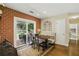 Inviting dining area with brick wall, banquette seating, and sliding door to the outdoor patio at 1925 Waters Ferry Dr, Lawrenceville, GA 30043