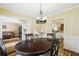 Dining room with hardwood floors, traditional decor, and an open view to the living spaces at 1925 Waters Ferry Dr, Lawrenceville, GA 30043