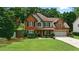 Charming two-story brick home with a well-manicured lawn and inviting curb appeal at 1925 Waters Ferry Dr, Lawrenceville, GA 30043