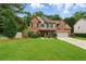Charming two-story brick home with a well-maintained front lawn and manicured landscaping at 1925 Waters Ferry Dr, Lawrenceville, GA 30043