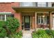 Inviting front porch with a charming entrance, brick facade, and decorative landscaping at 1925 Waters Ferry Dr, Lawrenceville, GA 30043