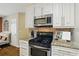 Kitchen showcasing stainless steel oven and microwave paired with light cabinets and granite countertops at 1925 Waters Ferry Dr, Lawrenceville, GA 30043