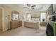 Spacious bedroom with a tray ceiling, ceiling fan, and a wooden furniture set at 1925 Waters Ferry Dr, Lawrenceville, GA 30043