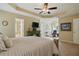 Spacious bedroom with a tray ceiling, ceiling fan, a painted fireplace and an ensuite bathroom at 1925 Waters Ferry Dr, Lawrenceville, GA 30043