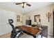 Office features a desk with a large computer and storage; neutral walls with a ceiling fan at 1925 Waters Ferry Dr, Lawrenceville, GA 30043