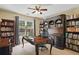 Spacious office with custom built-in bookshelves, a desk, and a view of the backyard at 1925 Waters Ferry Dr, Lawrenceville, GA 30043