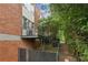 Backyard features grass, a chainlink fence, brick wall, and mature trees at 195 Arizona Ne Ave # 197, Atlanta, GA 30307