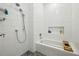 Bright, newly renovated bathroom with white tile, modern fixtures, and a recessed shower shelf at 195 Arizona Ne Ave # 197, Atlanta, GA 30307