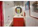 A stylish bathroom with a red vanity, round mirror, and a red shower curtain for a pop of color at 195 Arizona Ne Ave # 197, Atlanta, GA 30307