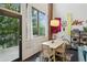 Cozy dining area with natural light, view of the outdoor trees, and brick wall at 195 Arizona Ne Ave # 197, Atlanta, GA 30307