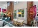 Stylish dining room with exposed brick, large windows, and seamless connection to the kitchen and living areas at 195 Arizona Ne Ave # 197, Atlanta, GA 30307