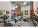 Bright living room boasts exposed brick walls, large windows, modern lighting, and stylish contemporary furnishings at 195 Arizona Ne Ave # 197, Atlanta, GA 30307