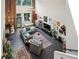 Open living room features soaring ceilings, exposed brick, and abundant natural light at 195 Arizona Ne Ave # 197, Atlanta, GA 30307
