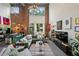 Spacious living room with high ceilings, exposed brick, modern lighting, and open floor plan to dining and kitchen at 195 Arizona Ne Ave # 197, Atlanta, GA 30307