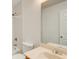 The bathroom has a tile shower, cream-colored sink, neutral paint, and a large mirror at 202 Garden Ct, Atlanta, GA 30328