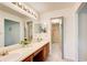 Bathroom with double sinks, vanity, and a view into the walk-in closet at 202 Garden Ct, Atlanta, GA 30328