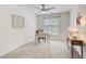 Cozy bedroom featuring a ceiling fan, desk, neutral carpet and paint, and ample natural light from the windows at 202 Garden Ct, Atlanta, GA 30328