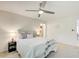 Comfortable bedroom featuring a ceiling fan, large windows, and plush carpet at 202 Garden Ct, Atlanta, GA 30328