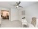 Bright bedroom with soft carpet, a desk and chair, and adjacent living area visible through open doorway at 202 Garden Ct, Atlanta, GA 30328