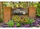 Elegant brick entrance sign for The Gardens at Dunwoody Springs, surrounded by lush, colorful landscaping at 202 Garden Ct, Atlanta, GA 30328