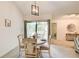 Cozy dining area with stylish light fixture and sliding glass door to a deck at 202 Garden Ct, Atlanta, GA 30328