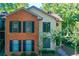 Charming two-story home with brick and siding exterior, complemented by lush landscaping at 202 Garden Ct, Atlanta, GA 30328