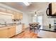 Cozy kitchen with wood cabinets, modern appliances, dining table, and hardwood floors at 202 Garden Ct, Atlanta, GA 30328