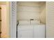 Convenient laundry room featuring a washer, dryer, and built-in shelving for efficient storage at 202 Garden Ct, Atlanta, GA 30328