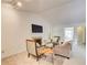 Well-lit living room with a fireplace, cozy seating, and access to other rooms at 202 Garden Ct, Atlanta, GA 30328