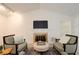 Inviting living room featuring a fireplace, comfortable seating, and ample natural light at 202 Garden Ct, Atlanta, GA 30328