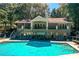 Expansive pool area with sun loungers and two-story building, perfect for relaxing and entertaining at 202 Garden Ct, Atlanta, GA 30328