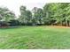 Green backyard with large trees and fence at 306 Mill Rdg, Canton, GA 30114
